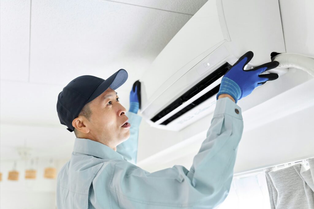 Worker installing air conditioner